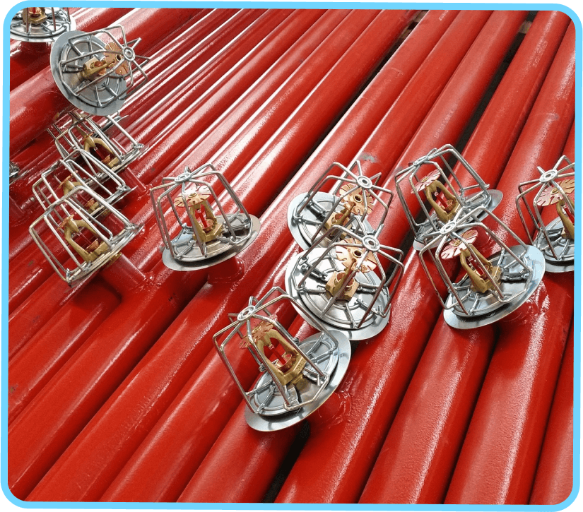 A group of red pipes with cages on top.