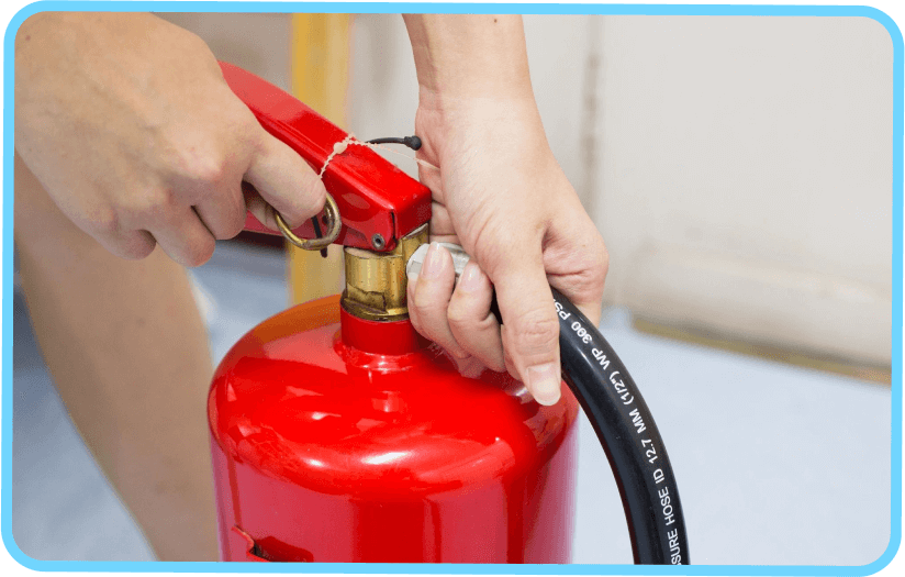 A person is holding onto the fire extinguisher