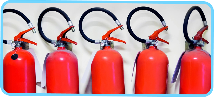 Three red fire extinguishers are lined up against a wall.